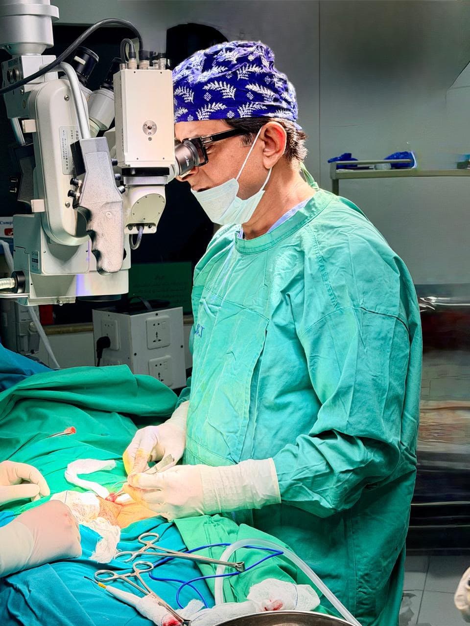 Prof. Dr. Asif Baloch performing a microsurgical procedure using a surgical microscope in an operating room